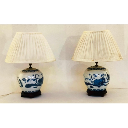 252 - TABLE LAMPS, 58cm H, a pair, Chinese blue and white ceramic of jar form with carved wooden bases and... 