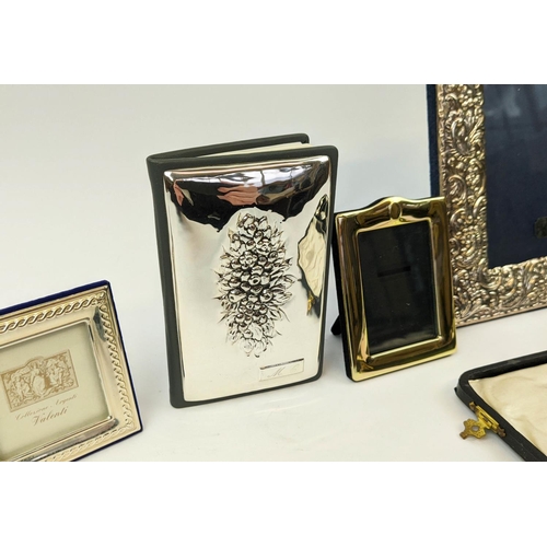 15 - A COLLECTION OF SILVERWARE, comprising Rococo embossed photo frame, three smaller photo frames, a ma... 