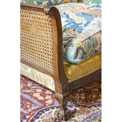 289 - BERGERE SOFA, 76cm H x 147cm W, early 20th century with double caned arms and loose cushions in drag... 