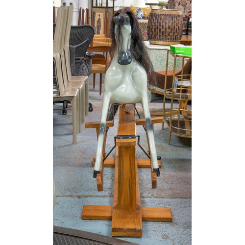 277 - ROCKING HORSE, 129cm H x 180cm L x 56cm W, painted fibreglass with leather saddle on wood stand.