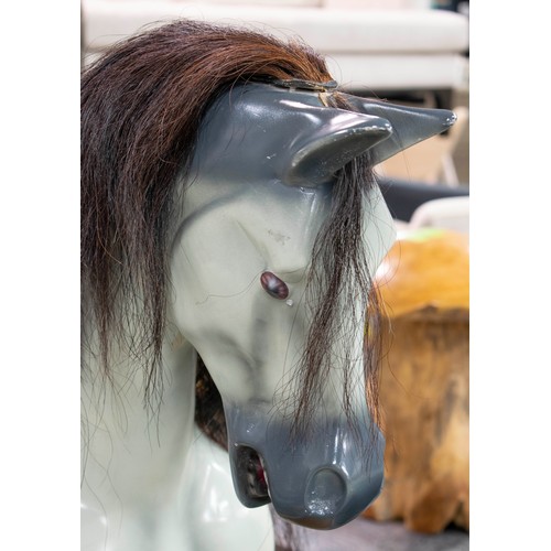 277 - ROCKING HORSE, 129cm H x 180cm L x 56cm W, painted fibreglass with leather saddle on wood stand.