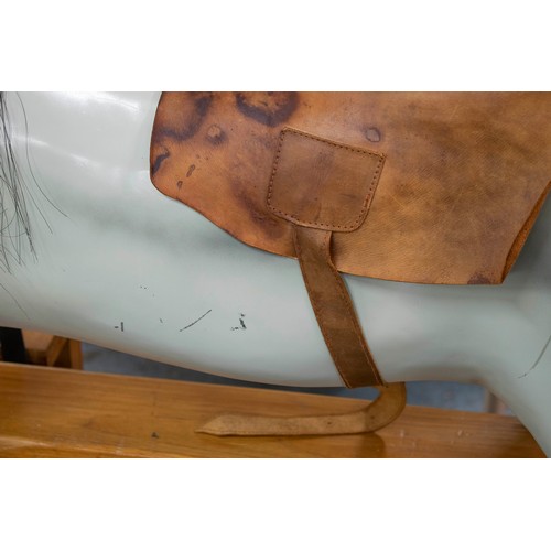 277 - ROCKING HORSE, 129cm H x 180cm L x 56cm W, painted fibreglass with leather saddle on wood stand.