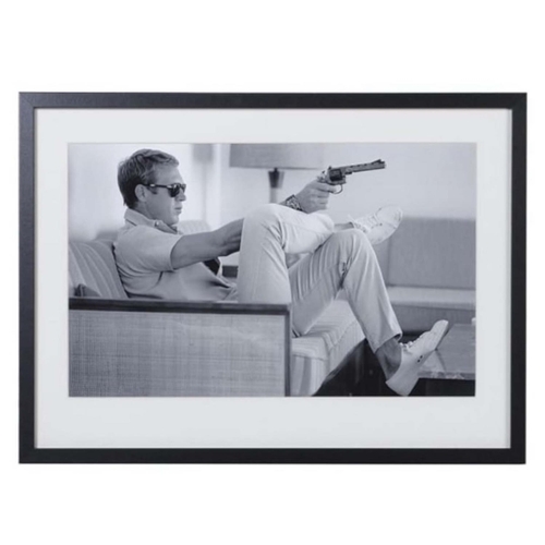 472 - AFTER JOHN DOWNING, Steve McQueen with gun, 54cm x 74cm, framed and glazed.