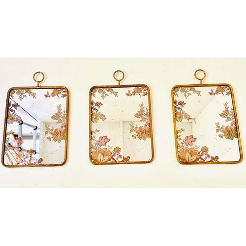 477 - WALL MIRRORS, a set of three, gilt frames with floral decoration to plate, 65cm x 40cm. (3)