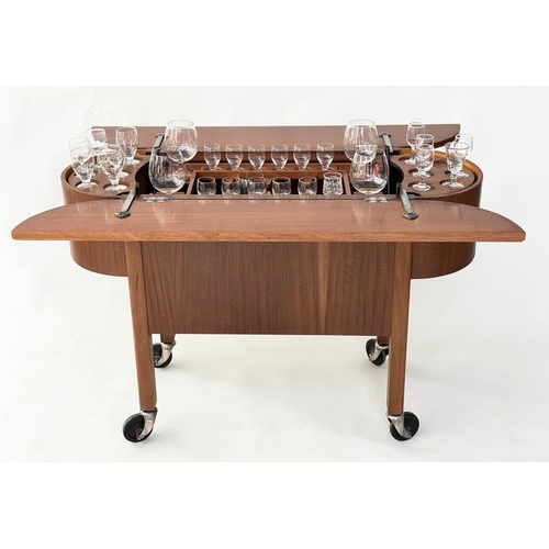 298 - COCKTAIL TROLLEY, 1950s mahogany oval opening foldout filled, rising interior with castors, 115cm W ... 