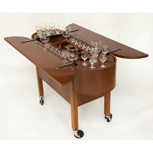 298 - COCKTAIL TROLLEY, 1950s mahogany oval opening foldout filled, rising interior with castors, 115cm W ... 