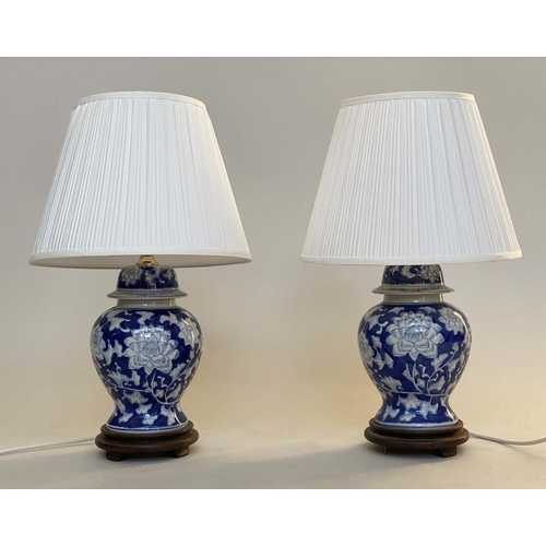 135 - TABLE LAMPS, a pair, Chinese blue and white ceramic of vase form with carved wooden bases and shades... 