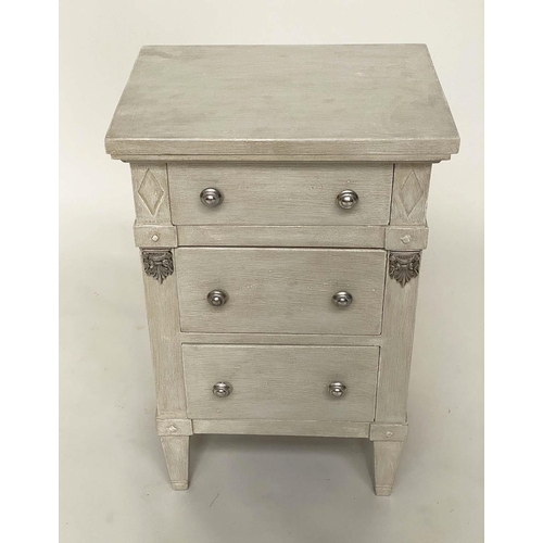 120 - BEDSIDE CHESTS, a pair, Gustavian style grey painted and silvered metal mounted each with three draw... 