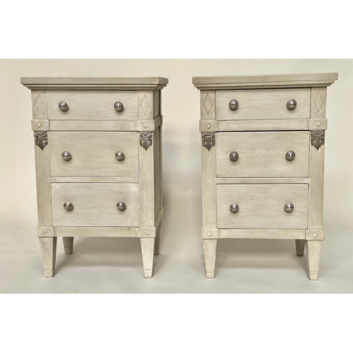 120 - BEDSIDE CHESTS, a pair, Gustavian style grey painted and silvered metal mounted each with three draw... 