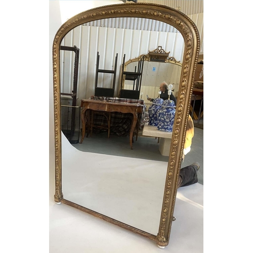 138 - OVERMANTEL MIRROR, Victorian giltwood and gesso moulded of arched outline with beaded and moulded fr... 