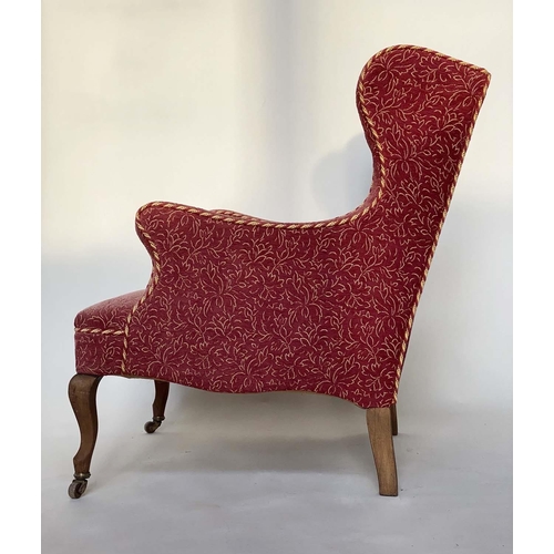 149 - WING ARMCHAIR, early 20th century deep seated of serpentine top and front with faded rose weave and ... 