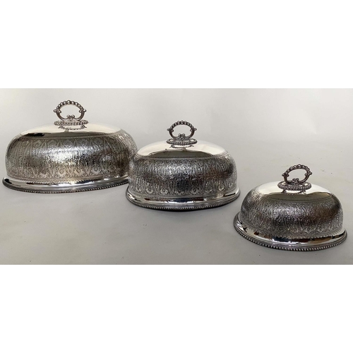 244 - DINNER DOME/COVERS, a graduated set of three early 20th century silver plated and engraved monogram,... 