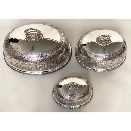 244 - DINNER DOME/COVERS, a graduated set of three early 20th century silver plated and engraved monogram,... 