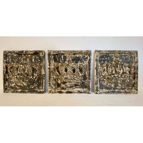 526 - CROWN WALL RELIEF PLAQUES, a set of three, aged painted finish 50cm x 50cm each.