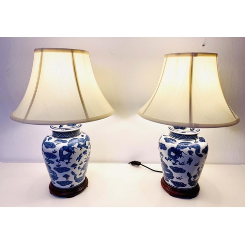 524 - TABLE LAMPS, pair, 60cm H x 40cm diam., Chinese export style blue and white ceramic, neutral dragon ... 