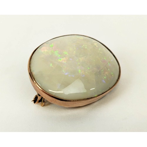 16 - A YELLOW METAL AND OPAL SET BROOCH, probably 9ct rose gold, spiders web design to back, the oval cab... 