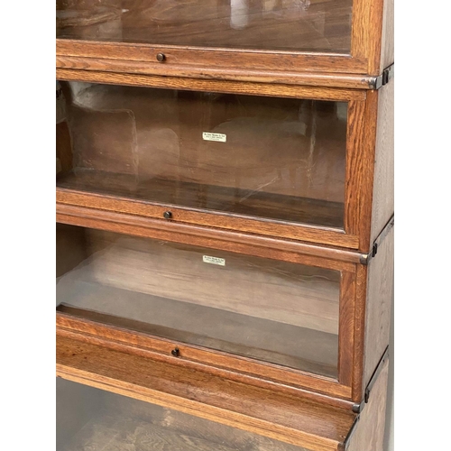 152 - GLOBE WERNICKE BOOKCASE, a graduated set of five, oak stacking glazed with cornice, plinth and label... 