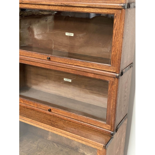 152 - GLOBE WERNICKE BOOKCASE, a graduated set of five, oak stacking glazed with cornice, plinth and label... 