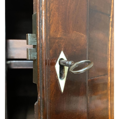 156 - LINEN PRESS, George III flame mahogany with oval panelled doors enclosing original trays and well sp... 