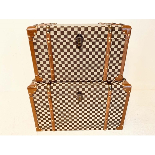 473 - TRUNKS, graduated pair, 42cm high, 72cm wide, 42cm deep, damier style upholstered. (2)