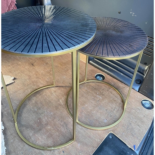 379 - NEST OF TABLES, a graduated pair, 62cm x 45cm diam. at largest, sunburst design tops in differing co... 