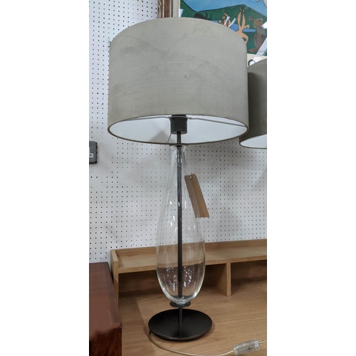 409 - TABLE LAMPS, a pair, grey shades, glass bases of ovoid form, black metal circular bases, 77cm H. (2)