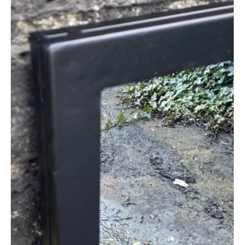 418 - ARCHITECTURAL GARDEN MIRRORS, a pair, black metal frames, 90cm x 99cm.