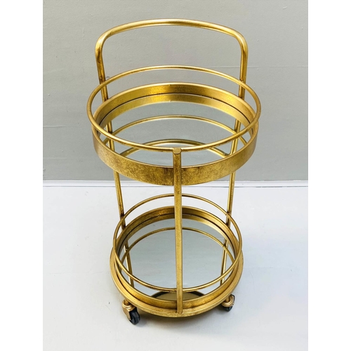 423 - COCKTAIL TROLLEY, 77cm high, 42cm diameter, 1960s French style, gilt metal frame with glass shelves