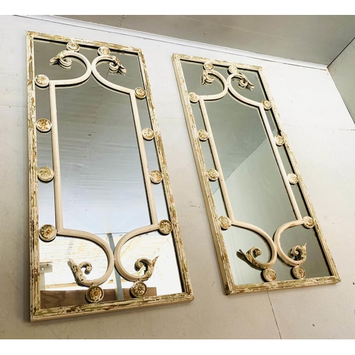 425 - ARCHITECTURAL WALL MIRRORS, a pair, aged metal frames, Italian style design, 112cm x 48cm.