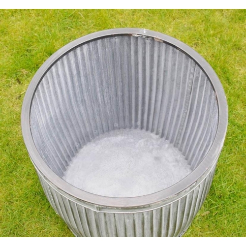 426 - GARDEN PLANTERS, a graduated set of three, largest 50cm high x 45cm diam., galvanised finish.