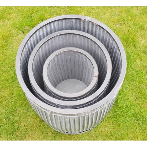 426 - GARDEN PLANTERS, a graduated set of three, largest 50cm high x 45cm diam., galvanised finish.