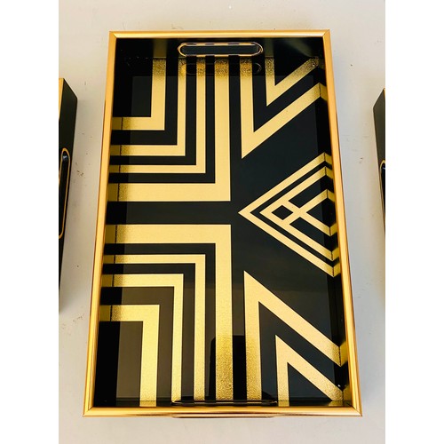 413 - COCKTAIL TRAYS, a set of 3, black and gold art deco style design, 5cm x 40cm x 25cm.