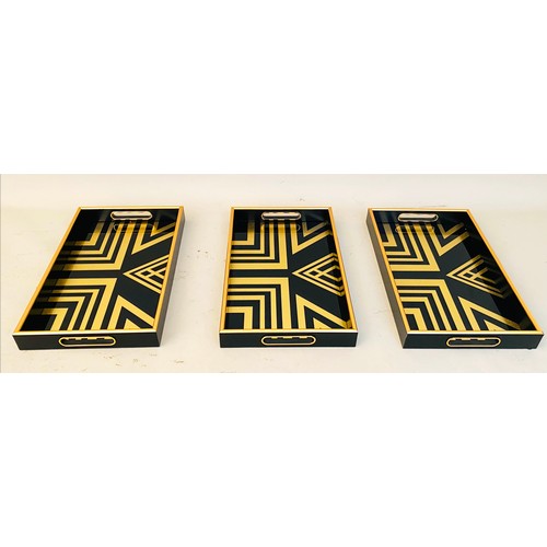 413 - COCKTAIL TRAYS, a set of 3, black and gold art deco style design, 5cm x 40cm x 25cm.