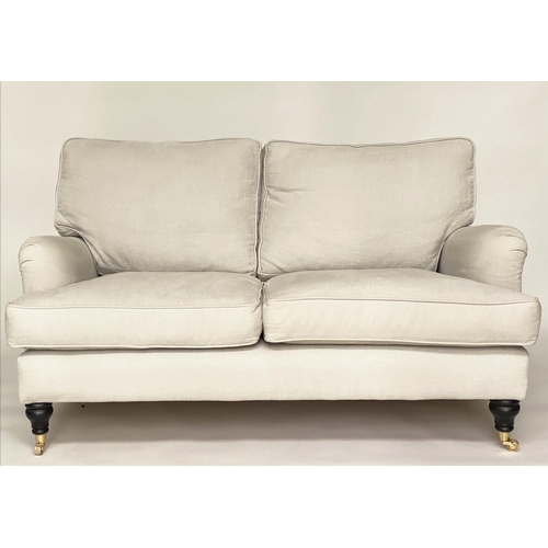 148 - SOFA, Howard style, linen upholstered with feather filled cushions and turned supports with castors ... 