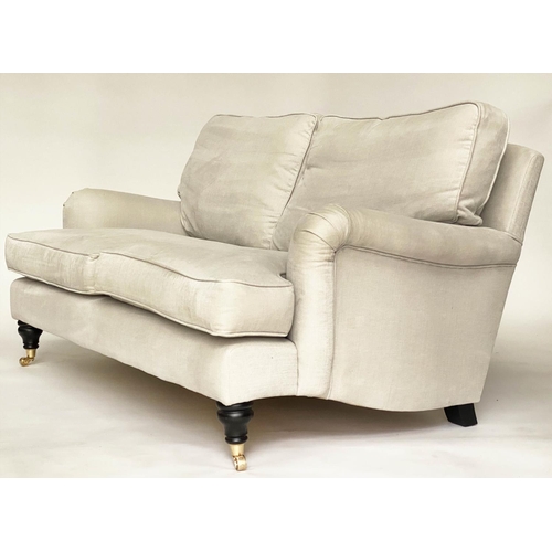 148 - SOFA, Howard style, linen upholstered with feather filled cushions and turned supports with castors ... 