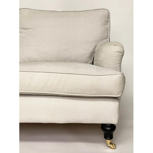 148 - SOFA, Howard style, linen upholstered with feather filled cushions and turned supports with castors ... 