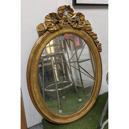 WALL MIRROR, 110cm x 76cm W, 19th century French giltwood with decorative ribbon surmount and oval pate.