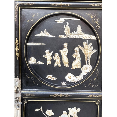 100 - CHINESE SIDE CABINET, early 20th century lacquered and mother and pearl and bone mounted with two pa... 