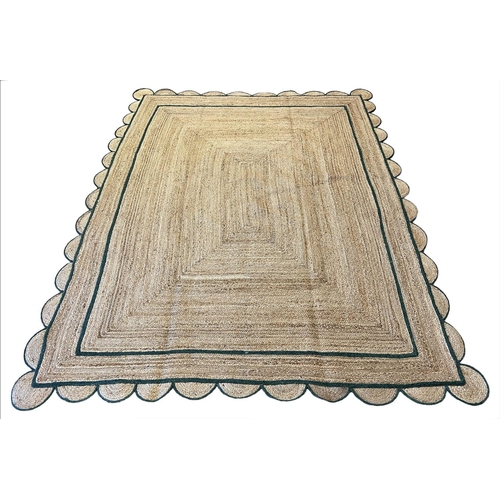 221 - SCALLOPED EDGE JUTE RUG, 307cm x 238cm.