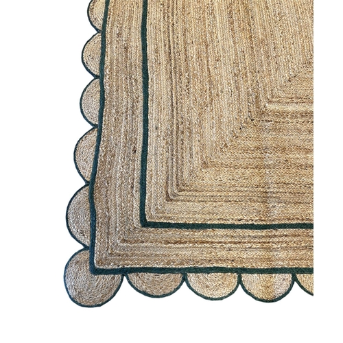 221 - SCALLOPED EDGE JUTE RUG, 307cm x 238cm.