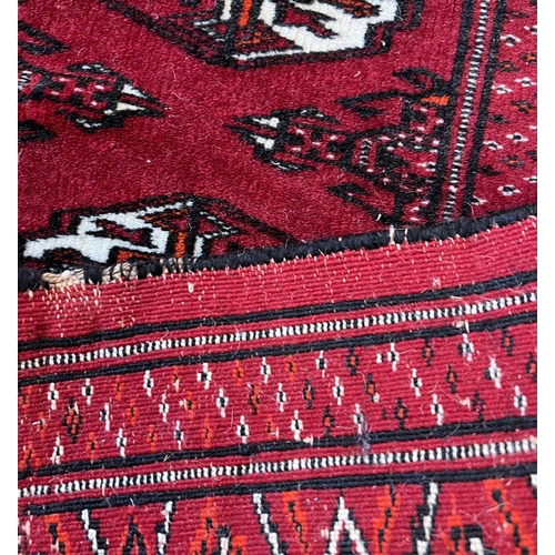 224 - PERSIAN RUG, 167cm x 105cm, together with a bokhara rug, 160cm x 115cm. (2)