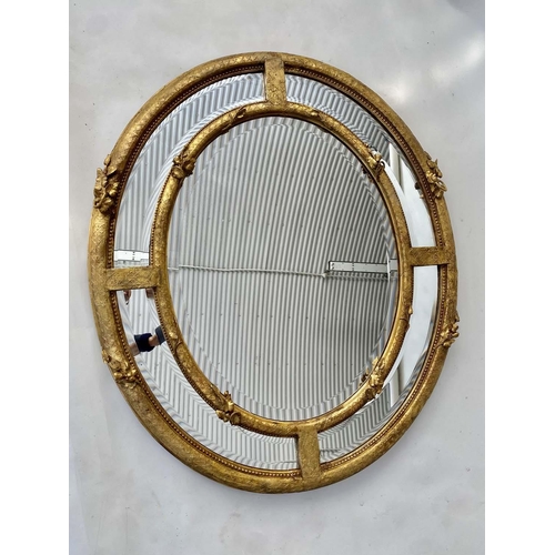 101 - WALL MIRROR, 19th century French giltwood and gesso moulded with oval and marginal bevelled mirror p... 