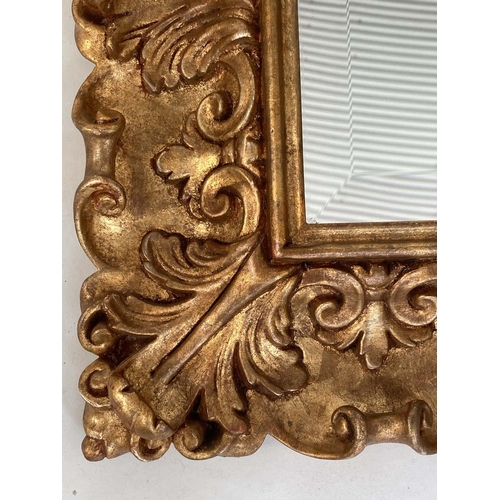 98 - WALL MIRROR, Italian carved giltwood rectangular with bevelled plate and foliate carved frame by 'Si... 