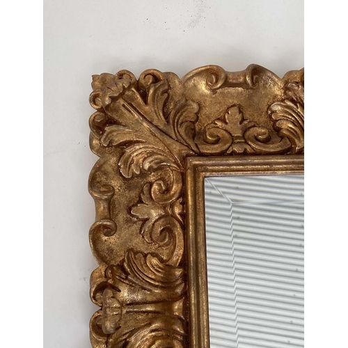 98 - WALL MIRROR, Italian carved giltwood rectangular with bevelled plate and foliate carved frame by 'Si... 