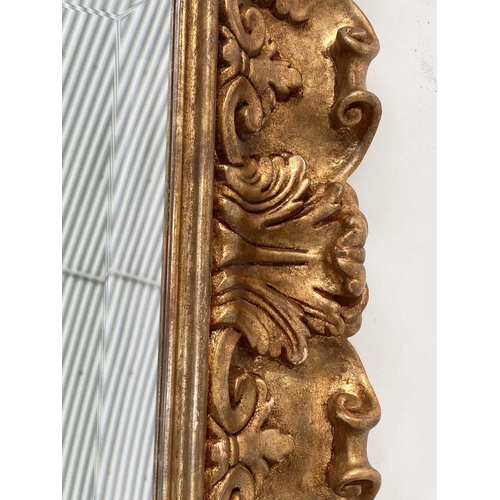 98 - WALL MIRROR, Italian carved giltwood rectangular with bevelled plate and foliate carved frame by 'Si... 