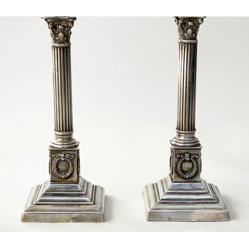 198 - CANDLESTICKS, a pair, 19th century silvered Corinthian capped, reeded column, wreath stepped weighte... 