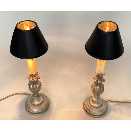 191 - TABLE LAMPS, a pair, Italian style carved silvered of candlestick form (with shades), 54cm H. (2)