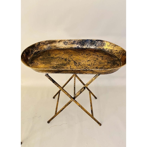 413 - TRAY TABLES, a pair, 66cm high, 68cm wide, 39cm, antiqued gilt metal finish. (2)