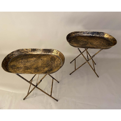 413 - TRAY TABLES, a pair, 66cm high, 68cm wide, 39cm, antiqued gilt metal finish. (2)