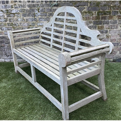 97 - LUTYENS STYLE GARDEN BENCH, weathered teak of slatted constructions after a design by Sir Edwin Luty... 